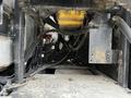 A 2007 Tennant Sentinel floor scrubber showing its machinery and components underneath the main body with visible cables and metal parts