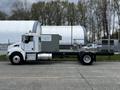 A 2014 Kenworth T370 truck featuring a gray utility box mounted on the chassis with a streamlined design and large wheels