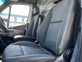 Interior view of a 2022 Mercedes-Benz Sprinter showing the driver's and passenger's seats with black fabric upholstery