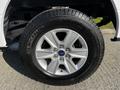 A close-up view of a 2017 Ford F-150 wheel featuring a five-spoke silver alloy rim and a Michelin tire with a rugged tread pattern