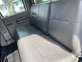 The image shows the back seat of a 2010 Ford F-550 with gray upholstery and a seatbelt on the right side