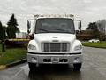 A 2007 Freightliner M2 106 truck facing forward with a white cab and silver bumper featuring a winch mounted on the front