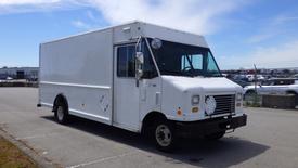 A white 2011 Ford Econoline box truck with side mirrors and a large front grille parked on a lot