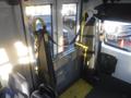 Interior view of a 2016 Chevrolet Express showing a foldable wheelchair ramp with safety straps and a yellow handle