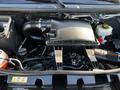 The engine compartment of a 2021 Mercedes-Benz Sprinter featuring a black air intake system and various engine components visible