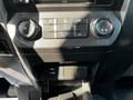 The interior console of a 2017 Ford F-150 featuring control knobs for air conditioning and a USB port