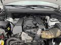 Image shows the engine compartment of a 2018 Jeep Grand Cherokee featuring a V8 engine with several hoses and components visible