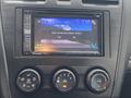 Dashboard of a 2014 Subaru Impreza showing a Pioneer audio system display with Bluetooth connection options and climate control dials