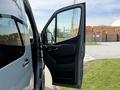 A 2019 Mercedes-Benz Sprinter with the driver's door open revealing the interior door handle and controls