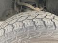 Close-up of a rugged tire tread from a 2009 Ford F-150 showcasing deep grooves and patterns for traction