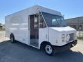 A white 2011 Ford Econoline box truck with an open side door and large cargo area visible from the front angle