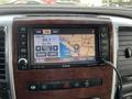 A 2010 Dodge Ram dashboard display showing a map with a navigation screen and radio controls