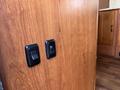 Black switches on a wooden panel with a smooth finish inside a vehicle