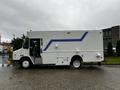 A 2005 Workhorse W-Series delivery truck is shown in profile view featuring a white body with a blue stripe along the side and various compartments on the exterior