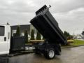 A 2005 GMC C5 Duramax dump truck with its bed raised, revealing the loading area and hydraulic lift mechanism