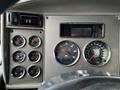 Dashboard of a 2014 Kenworth T370 featuring various gauges including speedometer fuel pressure engine temperature and oil pressure indicators