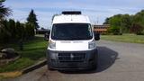 A white 2017 RAM Promaster van with a black grille and roof-mounted equipment positioned straight on in front view