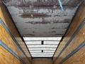 Interior view of an empty cargo area with a ceiling and wooden walls of a 2022 Ford F-750 truck