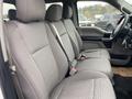 Interior of a 2017 Ford F-150 showing front seats with gray fabric upholstery and seat belts