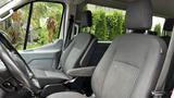 Interior of a 2017 Ford Transit featuring two front seats with fabric upholstery and adjustable headrests