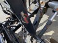 Close-up of a 2010 Ford F-550 front plow mount with the UltraMount logo visible on the bracket and attached hydraulic components.