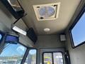 Interior view of a Freightliner MT45 garbage truck featuring a ceiling fan and multiple monitors mounted on the walls