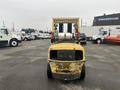 A yellow 2000 Hyster 120 forklift with a front-mounted gas cylinder and lifting forks positioned above the chassis