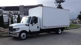 A 2012 International TerraStar truck with a white box cargo area parked on a street