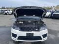 A 2020 Land Rover Range Rover Sport with the hood raised revealing the engine compartment