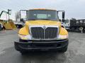 A yellow 2007 International 4300 truck with a prominent chrome grille and large headlights facing directly forward