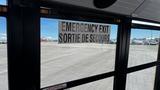 Emergency exit sign on a 2014 Freightliner Thomas Diesel bus showing both English and French text