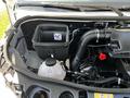 Under the hood of a 2022 Mercedes-Benz Sprinter showing the engine compartment with a coolant reservoir and an air intake duct