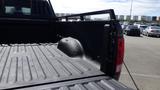 A 2014 RAM 3500 truck bed with a black liner and a raised rail for securing cargo