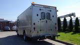 A silver 2005 Morgan Olson Workhorse vehicle with a boxy design featuring rear double doors and several lights on the roof