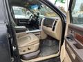 Interior of a 2010 Dodge Ram featuring leather seats a center console and door controls