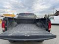 A 2010 Dodge Ram truck with an open bed showing a black liner and visible wear on the surface