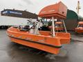 A 2008 Fassmer 20 Foot Fast Rescue boat in orange color with a high cabin and several seating areas designed for rapid response and rescue operations