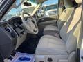 Interior of a 2013 Ford Expedition featuring beige leather seats and a dashboard with controls and steering wheel