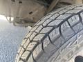 Close-up of a worn tire from a 1999 Ford Econoline showcasing the tread pattern and uneven wear on the rubber surface