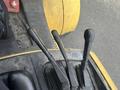 Close-up of the control levers of a 2000 Hyster 120 forklift featuring three black levers positioned on a gray panel