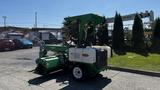 A 2017 Laymor SweepMaster 300 street sweeper with a green body and a rotating broom attachment in front