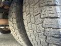 Close-up view of two tires from a 2012 Ford Econoline showing detailed tread patterns and textures