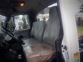 Interior of a 2006 International 4300 featuring two gray vinyl seats with visible wear and tear