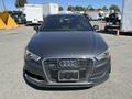 A 2016 Audi A3 with a gray exterior featuring a prominent front grille and sleek headlights