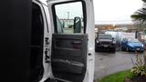 A 2008 Chevrolet C7500 with the driver’s door open showing the interior door panel and controls