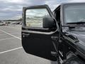 A black 2019 Jeep Wrangler with the driver's door open showcasing the interior elements