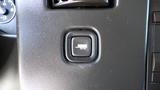 A button on the dashboard of a 2015 GMC Savana indicating a vehicle auxiliary feature with a truck symbol