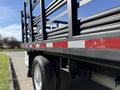 A 2016 Ford F-350 SD with a flatbed and black metal railing showcasing red reflective stripes on the side