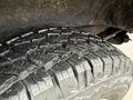 Close-up of a rugged tire tread from a 2009 Chevrolet Express showcasing deep grooves and a robust design