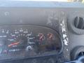 Dashboard of a 2008 Ford Econoline showing gauges for speed temperature and fuel with visible wear and dust